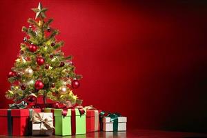 Christmas tree with red and gold decorations, with lots of presents underneath.