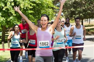 Woman winning race, co-ed competitors cheering